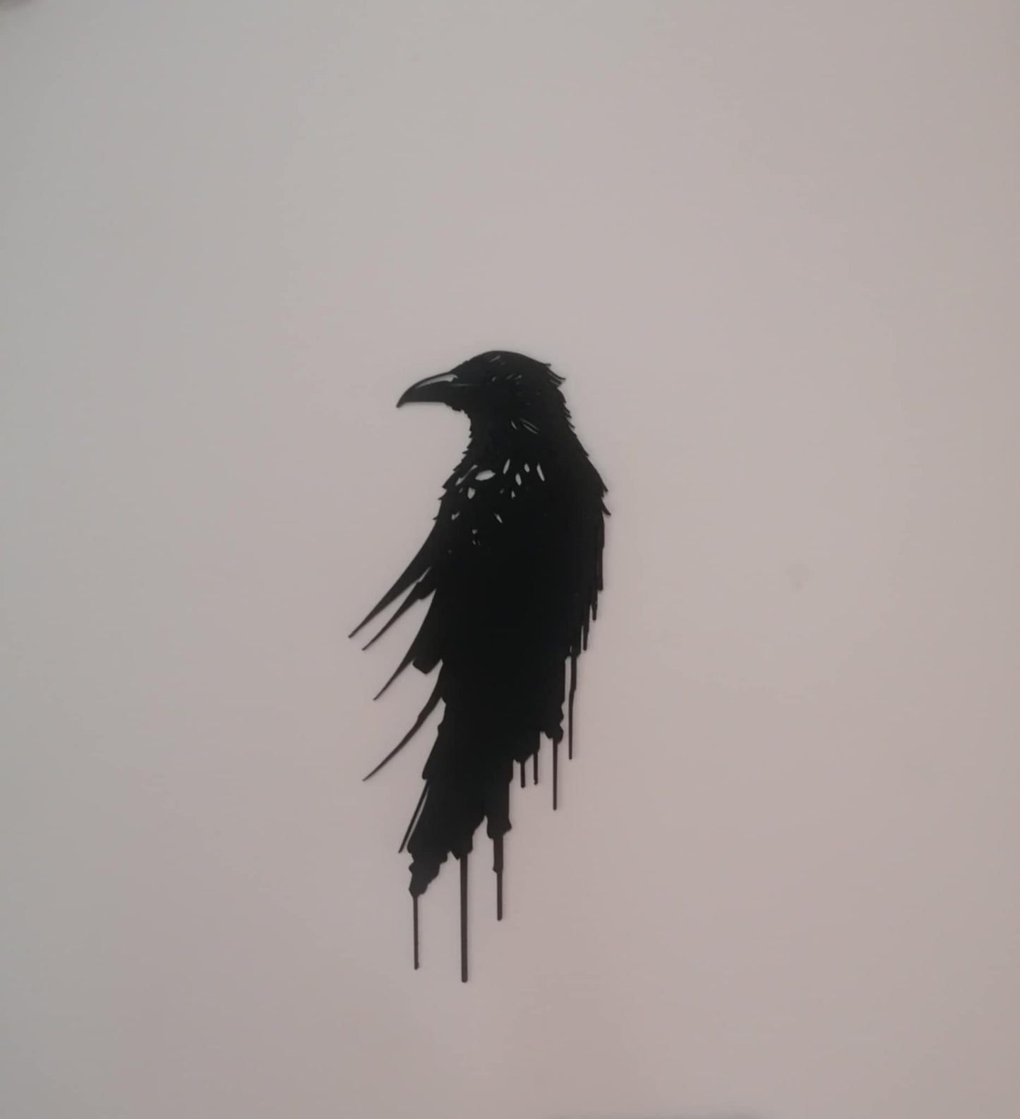 Black silhouette of a bird on a light gray background