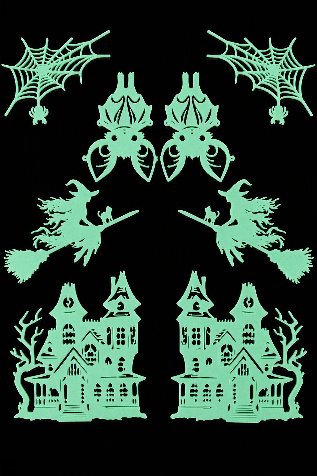Glow in the dark Halloween wall art set featuring two haunted houses, two flying witches with cats, two bats and two spider webs displayed on a black background.