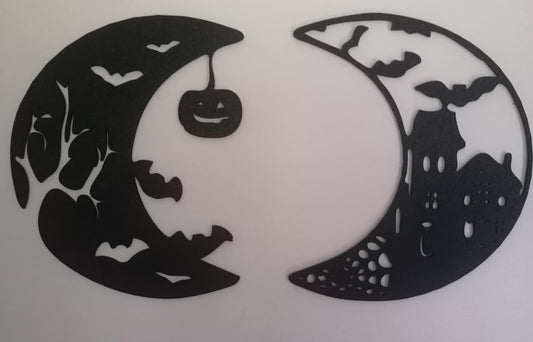 Two black crescent‑moon silhouettes featuring Halloween cut‑outs, including bats, branches, a haunted house, and a hanging jack‑o’-lantern, displayed on a white background.